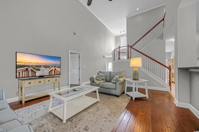 4232 Pointer Ct, Myrtle Beach, SC 29579 - living room featuring stairs, hardwood / wood-style floors, a towering ceiling, crown molding, and baseboards