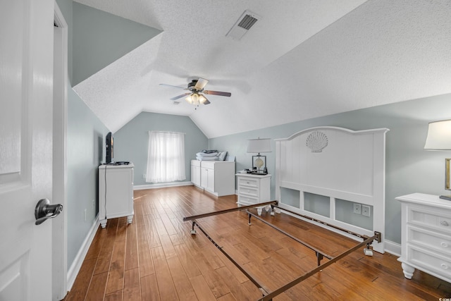 4232 Pointer Ct, Myrtle Beach, SC 29579 - bedroom with vaulted ceiling, a textured ceiling, hardwood / wood-style flooring, and baseboards