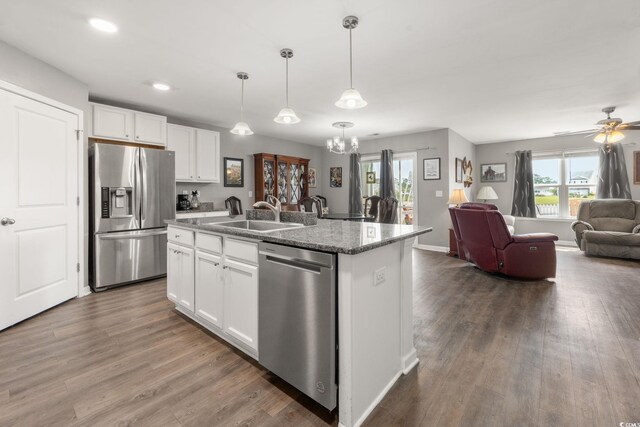 568 Mossbank Loop, Longs, SC 29568 - kitchen featuring appliances with stainless steel finishes, open floor plan, a chandelier, dark wood-style flooring, and white cabinetry