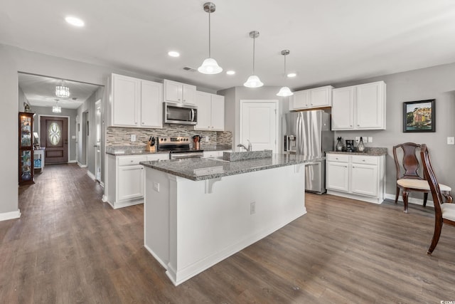 568 Mossbank Loop, Longs, SC 29568 - kitchen with stainless steel appliances, recessed lighting, white cabinetry, dark wood finished floors, and a kitchen island with sink