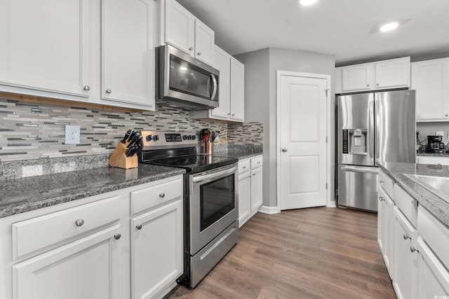 568 Mossbank Loop, Longs, SC 29568 - kitchen with stainless steel appliances, white cabinetry, decorative backsplash, wood finished floors, and recessed lighting