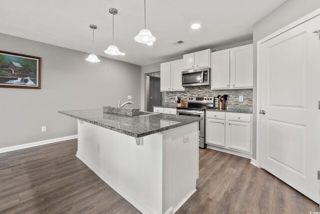 568 Mossbank Loop, Longs, SC 29568 - kitchen featuring appliances with stainless steel finishes, white cabinetry, backsplash, dark wood-style floors, and an island with sink