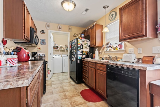 1222 Midtown Village Dr, Conway, SC 29526 - kitchen featuring black appliances, washer and clothes dryer, a sink, brown cabinetry, and pendant lighting