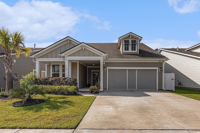 1741 Parish Way, Myrtle Beach, SC 29577 - view of front of home featuring an attached garage, a front lawn, board and batten siding, concrete driveway, and roof with shingles