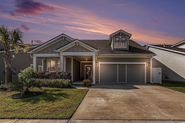 1741 Parish Way, Myrtle Beach, SC 29577 - craftsman house featuring an attached garage, driveway, a front lawn, board and batten siding, and a shingled roof