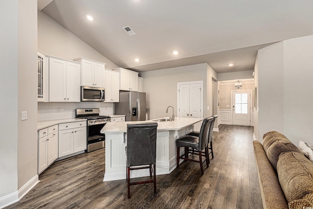 1741 Parish Way, Myrtle Beach, SC 29577 - kitchen featuring stainless steel appliances, a kitchen island with sink, backsplash, dark wood-type flooring, and vaulted ceiling