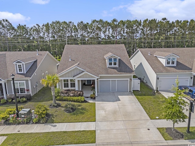 1741 Parish Way, Myrtle Beach, SC 29577 - view of front facade featuring concrete driveway, a front yard, a garage, board and batten siding, and a shingled roof