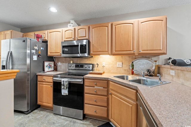 592 Riverward Dr Unit 592, Myrtle Beach, SC 29588 - kitchen featuring appliances with stainless steel finishes, a sink, light brown cabinets, decorative backsplash, and a textured ceiling