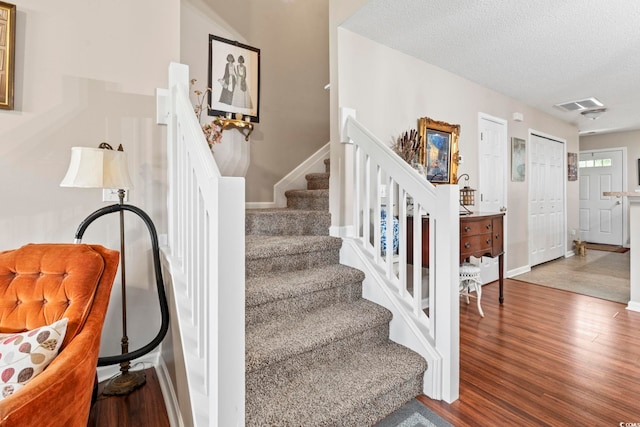 592 Riverward Dr Unit 592, Myrtle Beach, SC 29588 - stairs featuring wood finished floors, a textured ceiling, and baseboards