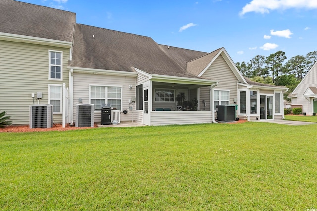 592 Riverward Dr Unit 592, Myrtle Beach, SC 29588 - back of house featuring a sunroom, central AC unit, a yard, and roof with shingles
