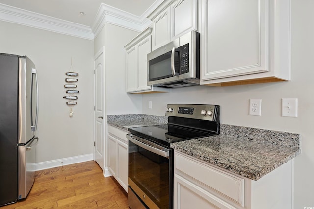 172 Ella Kinley Cir Unit 101, Myrtle Beach, SC 29588 - kitchen featuring appliances with stainless steel finishes, light wood finished floors, ornamental molding, stone counters, and white cabinetry