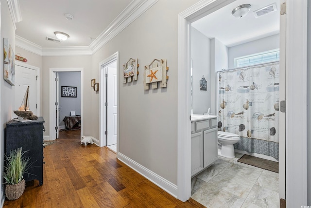 172 Ella Kinley Cir Unit 101, Myrtle Beach, SC 29588 - hallway featuring crown molding, baseboards, and light wood finished floors