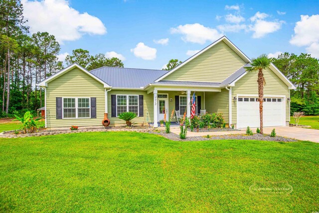1013 Happy Ln, Galivants Ferry, SC 29544 - view of front of property featuring a garage, a porch, concrete driveway, a front lawn, and metal roof