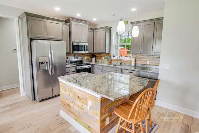 1013 Happy Ln, Galivants Ferry, SC 29544 - kitchen with appliances with stainless steel finishes, a sink, baseboards, tasteful backsplash, and light wood-type flooring