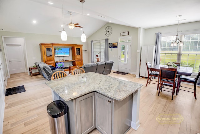 1013 Happy Ln, Galivants Ferry, SC 29544 - kitchen with open floor plan, light wood-style floors, ceiling fan, lofted ceiling, and light stone counters