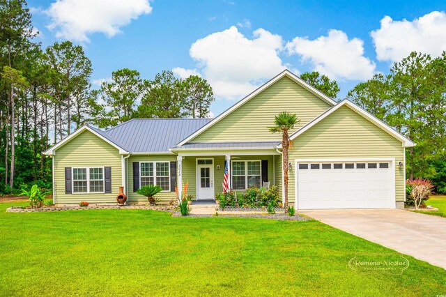 1013 Happy Ln, Galivants Ferry, SC 29544 - view of front facade featuring a garage, concrete driveway, covered porch, a front lawn, and metal roof