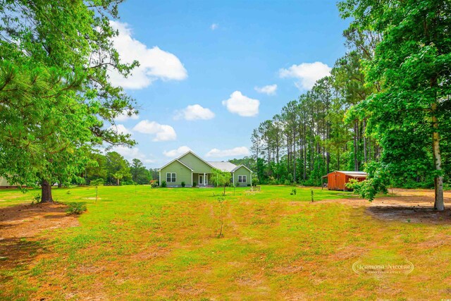 1013 Happy Ln, Galivants Ferry, SC 29544 - view of green lawn featuring an outbuilding