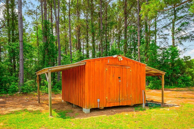 1013 Happy Ln, Galivants Ferry, SC 29544 - view of shed featuring a view of trees