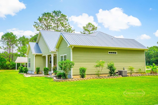 1013 Happy Ln, Galivants Ferry, SC 29544 - view of home's exterior with a lawn, metal roof, and central AC unit