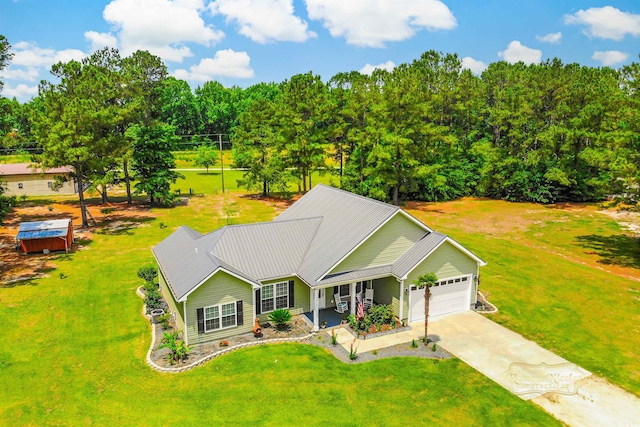 1013 Happy Ln, Galivants Ferry, SC 29544 - view of front of house featuring a garage, driveway, a front lawn, and metal roof