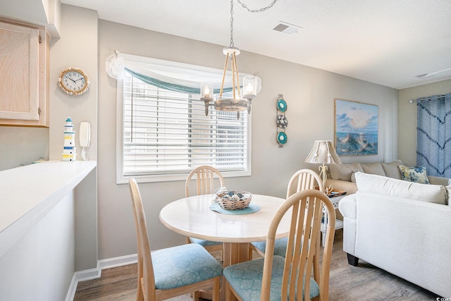 1900 Duffy St Unit L4, North Myrtle Beach, SC 29582 - dining room featuring wood finished floors, a chandelier, and baseboards