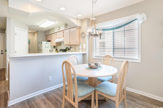 1900 Duffy St Unit L4, North Myrtle Beach, SC 29582 - dining space with dark wood-type flooring, a chandelier, baseboards, and recessed lighting