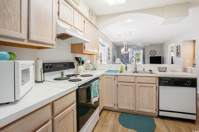 1900 Duffy St Unit L4, North Myrtle Beach, SC 29582 - kitchen with white appliances, a sink, under cabinet range hood, a peninsula, and light brown cabinets