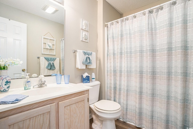 1900 Duffy St Unit L4, North Myrtle Beach, SC 29582 - full bathroom with vanity, toilet, a textured ceiling, and wood finished floors