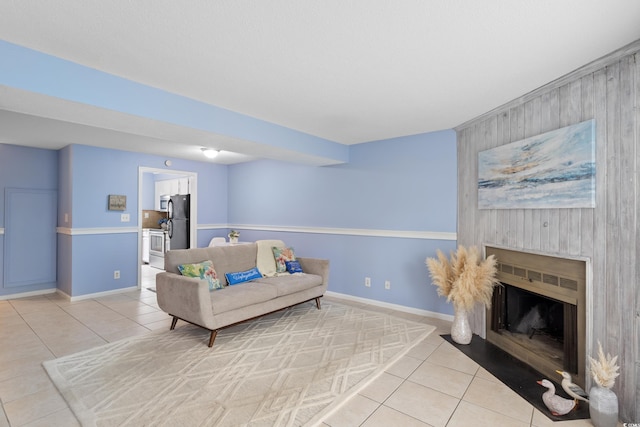 403 75th Ave N Unit C, Myrtle Beach, SC 29572 - living room with light tile patterned flooring, wood walls, an accent wall, baseboards, and a fireplace with flush hearth