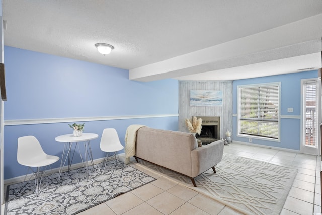 403 75th Ave N Unit C, Myrtle Beach, SC 29572 - tiled living area with a large fireplace, baseboards, and a textured ceiling