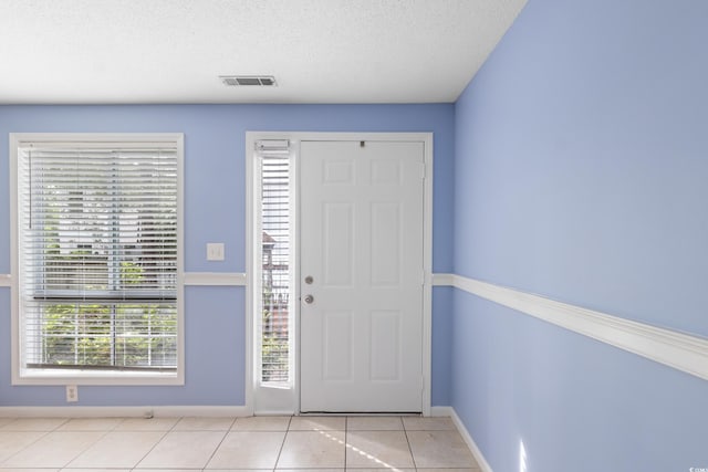 403 75th Ave N Unit C, Myrtle Beach, SC 29572 - foyer featuring light tile patterned floors, a textured ceiling, and baseboards