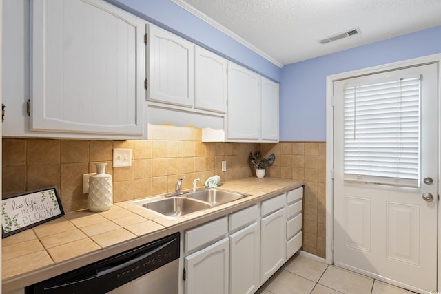 403 75th Ave N Unit C, Myrtle Beach, SC 29572 - kitchen featuring a sink, stainless steel dishwasher, tile counters, white cabinetry, and a textured ceiling