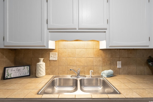 403 75th Ave N Unit C, Myrtle Beach, SC 29572 - kitchen featuring tile countertops, a sink, white cabinetry, and decorative backsplash