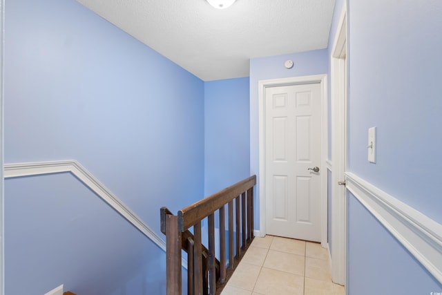 403 75th Ave N Unit C, Myrtle Beach, SC 29572 - corridor with light tile patterned floors, a textured ceiling, and an upstairs landing