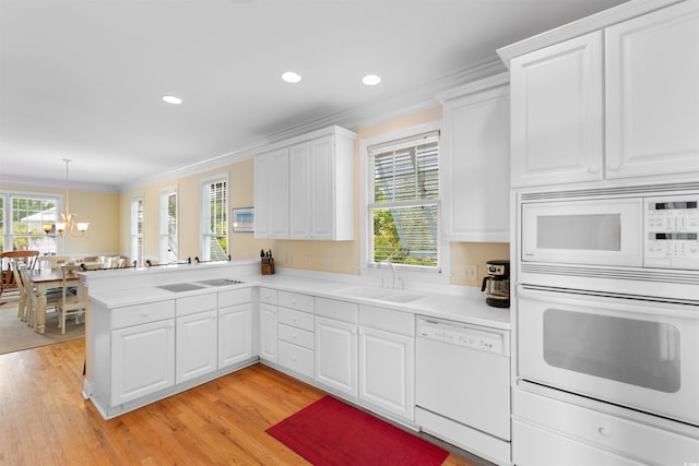141 Cayman Loop, Pawleys Island, SC 29585 - kitchen featuring white appliances, a sink, crown molding, a chandelier, and light countertops