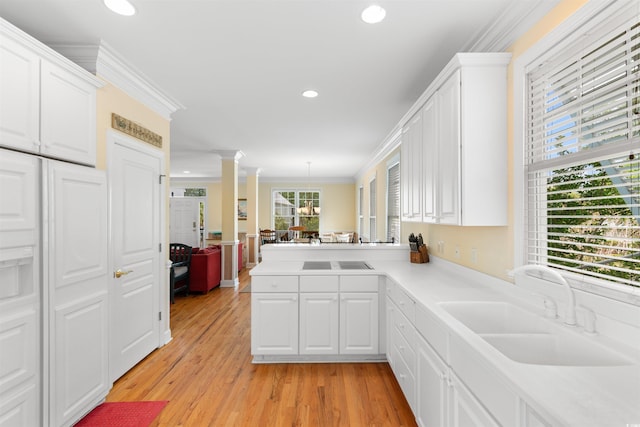 141 Cayman Loop, Pawleys Island, SC 29585 - kitchen with a sink, ornamental molding, white cabinets, recessed lighting, and light countertops
