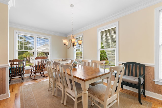 141 Cayman Loop, Pawleys Island, SC 29585 - dining room with ornamental molding, a chandelier, light wood-style flooring, and a wainscoted wall