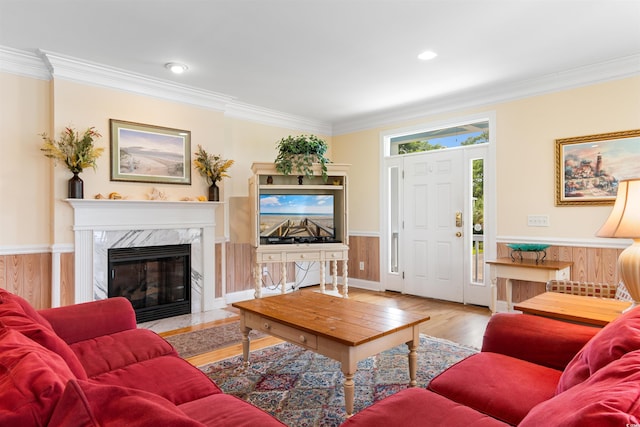 141 Cayman Loop, Pawleys Island, SC 29585 - living area featuring ornamental molding, wood finished floors, a premium fireplace, and wainscoting