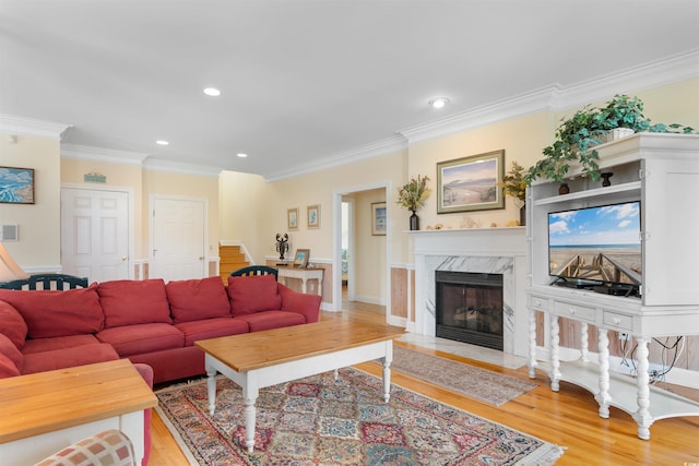 141 Cayman Loop, Pawleys Island, SC 29585 - living area featuring light wood-style floors, a fireplace, ornamental molding, recessed lighting, and stairway