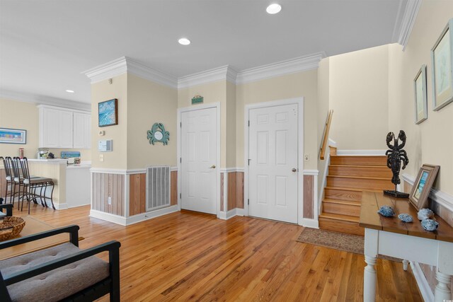 141 Cayman Loop, Pawleys Island, SC 29585 - foyer entrance with light wood-style floors, ornamental molding, stairs, and recessed lighting