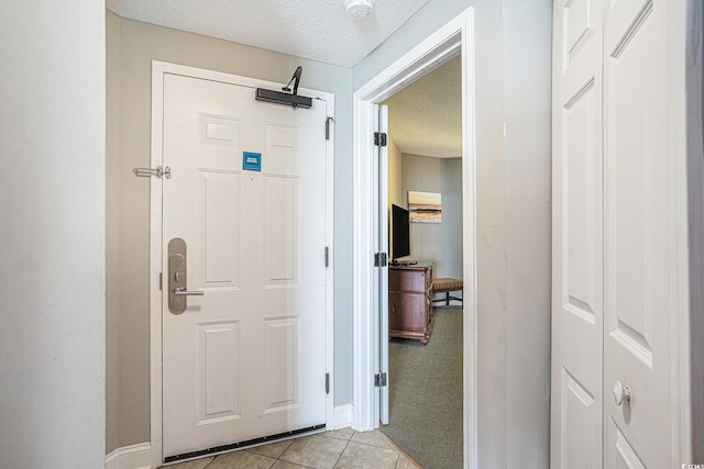 2600 N Ocean Blvd Unit 1406, Myrtle Beach, SC 29577 - hall with light tile patterned floors, a textured ceiling, and baseboards