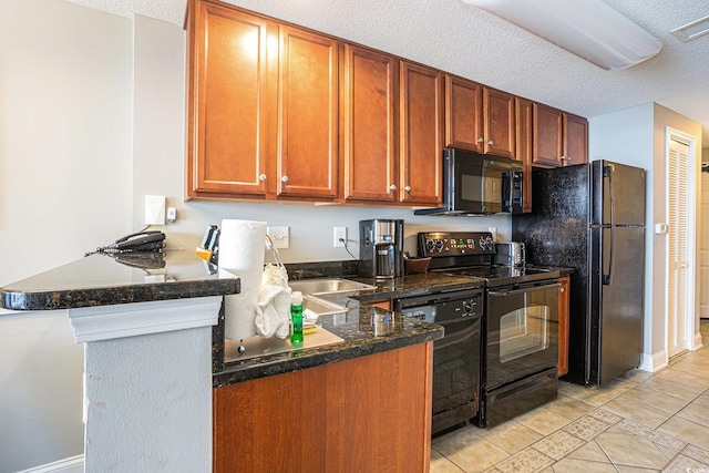 2600 N Ocean Blvd Unit 1406, Myrtle Beach, SC 29577 - kitchen with black appliances, a peninsula, light tile patterned floors, a textured ceiling, and baseboards