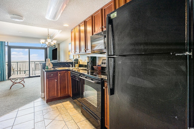 2600 N Ocean Blvd Unit 1406, Myrtle Beach, SC 29577 - kitchen with black appliances, a sink, dark countertops, a chandelier, and a textured ceiling