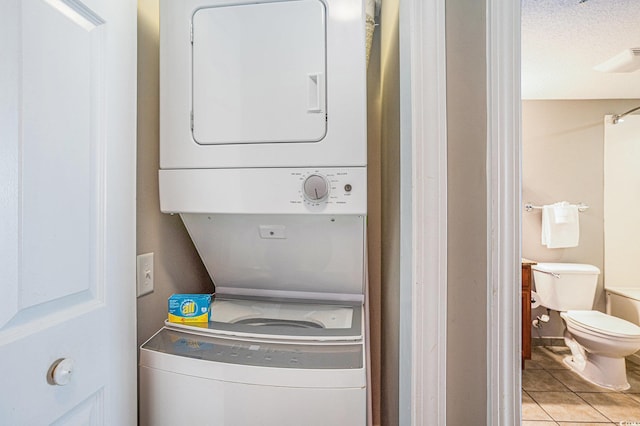 2600 N Ocean Blvd Unit 1406, Myrtle Beach, SC 29577 - washroom with stacked washer / drying machine and light tile patterned floors