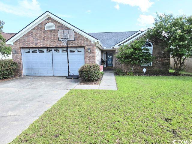2707 Canvasback Trl, Myrtle Beach, SC 29588 - ranch-style home featuring brick siding, an attached garage, a front yard, driveway, and roof with shingles