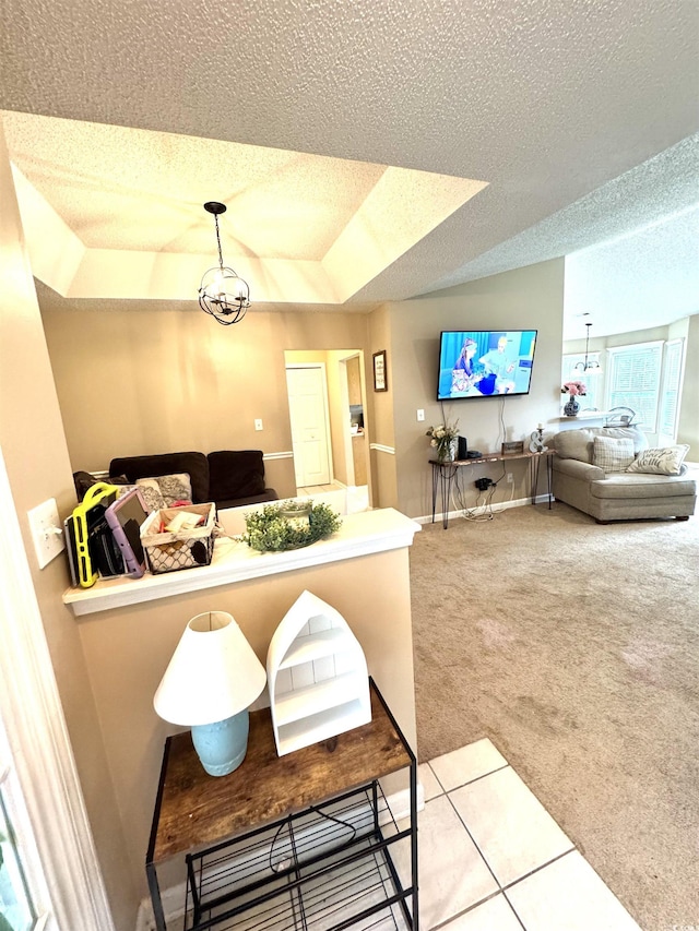 2707 Canvasback Trl, Myrtle Beach, SC 29588 - carpeted living room featuring a textured ceiling, a raised ceiling, and baseboards