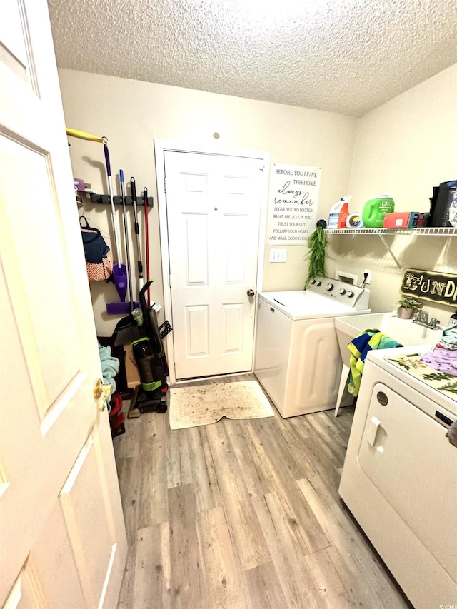 2707 Canvasback Trl, Myrtle Beach, SC 29588 - washroom with separate washer and dryer, light wood-type flooring, and a textured ceiling