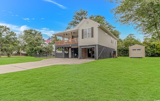 4600 Murrells Inlet Rd, Murrells Inlet, SC 29576 - back of house with stairway, a ceiling fan, a shed, a lawn, and concrete driveway
