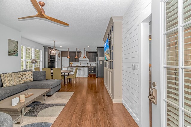 4600 Murrells Inlet Rd, Murrells Inlet, SC 29576 - living room featuring a textured ceiling, wood finished floors, ceiling fan, a chandelier, and recessed lighting