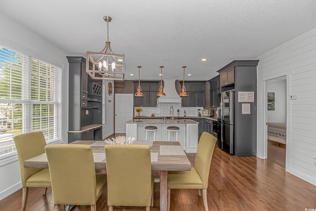4600 Murrells Inlet Rd, Murrells Inlet, SC 29576 - dining area featuring a chandelier, dark wood-type flooring, a textured ceiling, and wooden walls
